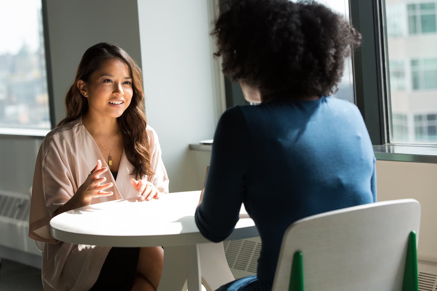 Two women in conversation across a table